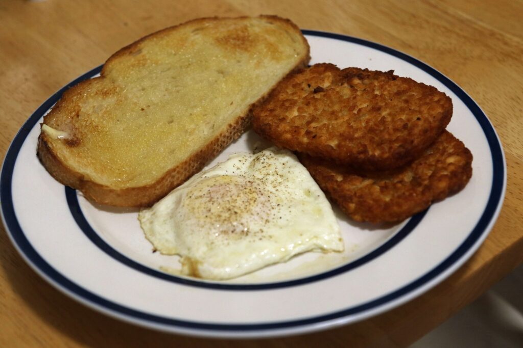a white plate topped with fried eggs and toast